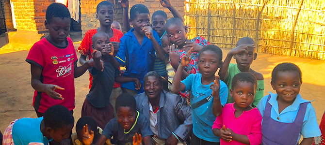 670x300_Day2_01_NuSkin A group of children from the Community Based Child Care in Malawi pose for a picture.