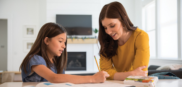 girl with mother sitting at counter with package of mighty minds