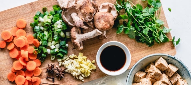 wooden cutting board with chopped vegetables; photo by Ella Olsson