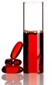 Red pills stacked on top of each other and a glass tube filled partially with an identical red fluid.