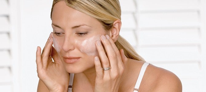 woman applying face wash 