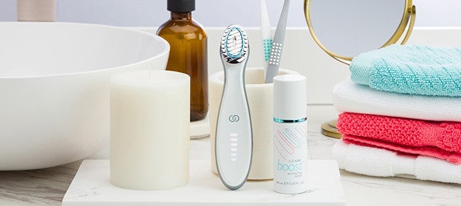 nu skin skin care device ageloc boost and serum on bathroom counter