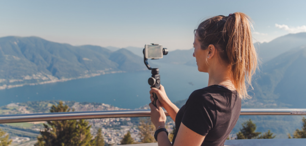 girl taking photo of mountain scape