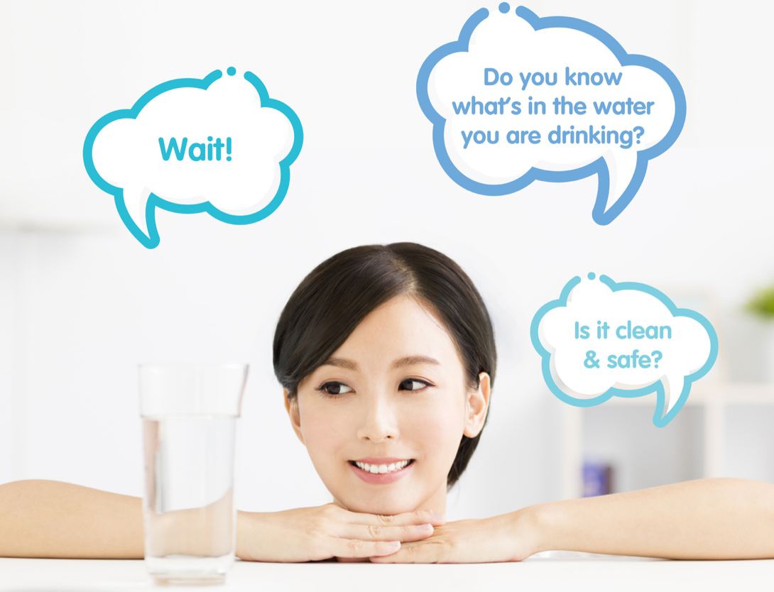 A woman looking at a glass of water questioning if the water is clean and safe.