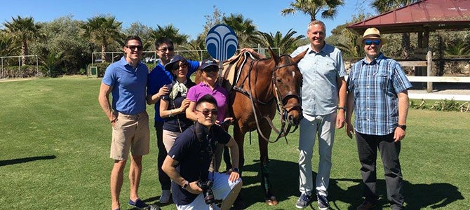 Nu Skin Sales Leaders, Blake Roney, and Ryan Napierski pose for a picture with a donkey at the Santa Maria Polo Club. title=